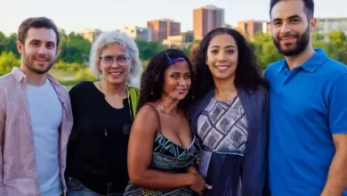 A diverse group of people standing together, supporting each other, with a mental health community center in the background
