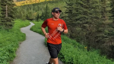 A person jogging on a scenic trail surrounded by nature