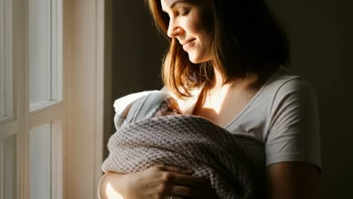 A calm, smiling new mother holding her baby, surrounded by a soft, peaceful atmosphere