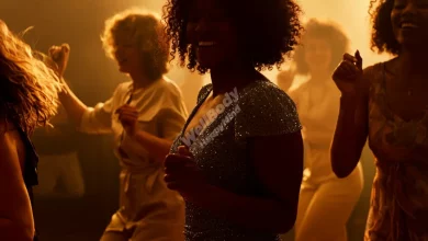 A diverse group of people dancing joyfully together, with visible expressions of happiness