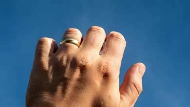 A strong hand drawing boundaries, set against a calm blue sky for a peaceful mind.