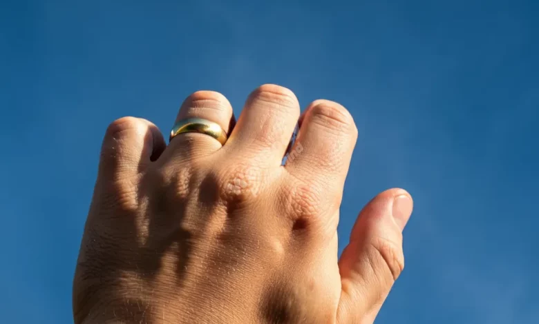 A strong hand drawing boundaries, set against a calm blue sky for a peaceful mind.