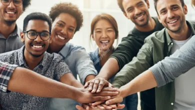 A diverse group of people from different ages and backgrounds, standing together and smiling, representing a supportive community