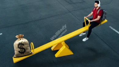 A person balancing on a seesaw with money on one side and a heart on the other, symbolizing emotional financial balance