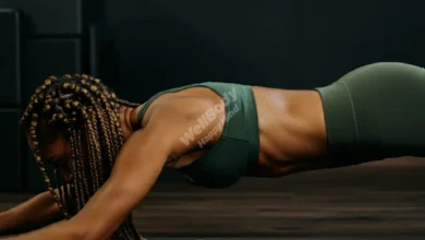 A person performing a Pilates exercise on a mat, focusing on core engagement