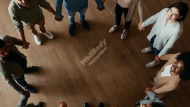 A diverse group of people holding hands in a circle, shot from above, warm natural lighting, soft colors, representing unity and connection