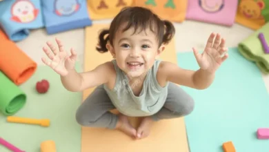 A smiling child in a playful yoga pose surrounded by colorful, cartoon-style yoga mats and props